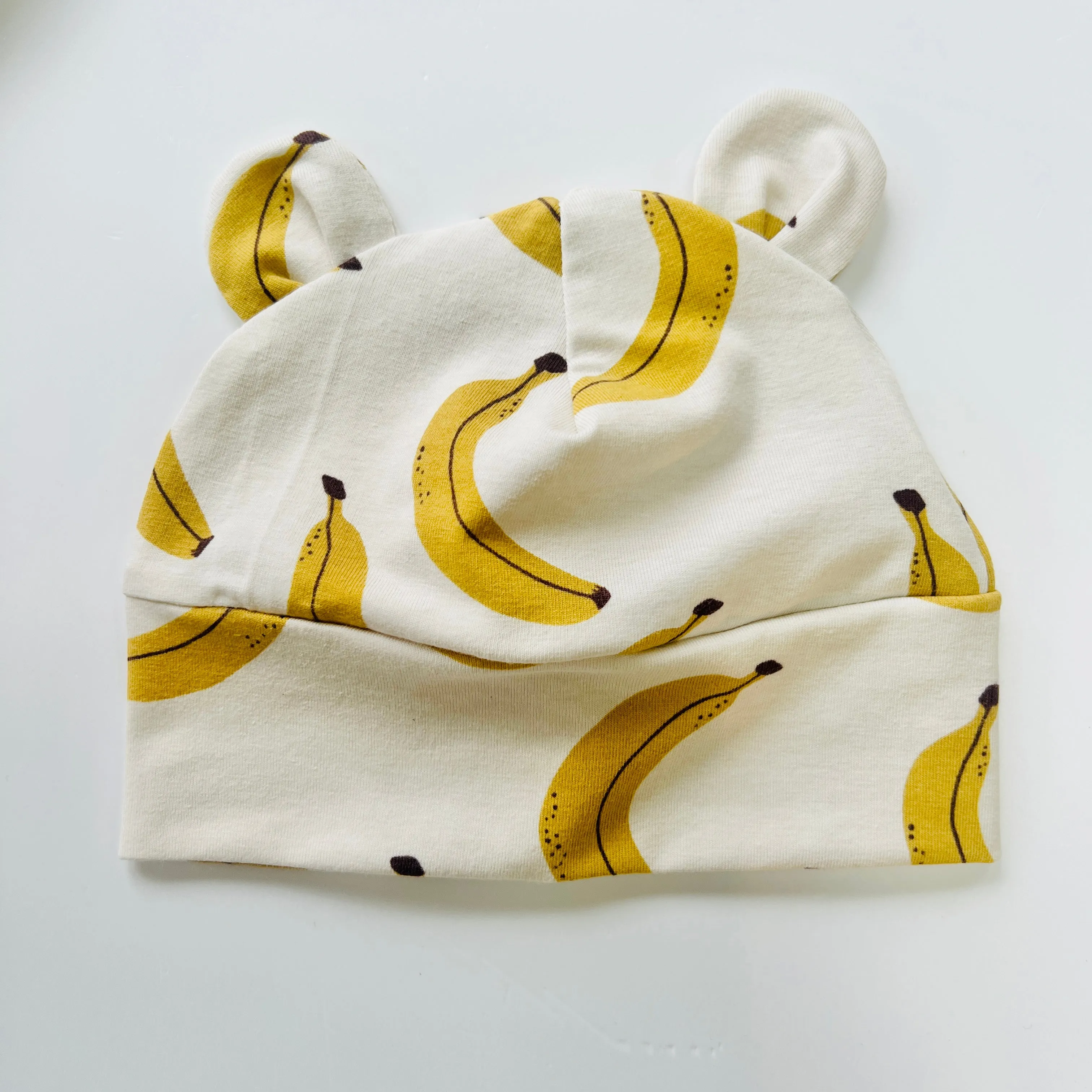 Eddie & Bee organic cotton Baby hat with ears  in Cream "Banana” print.